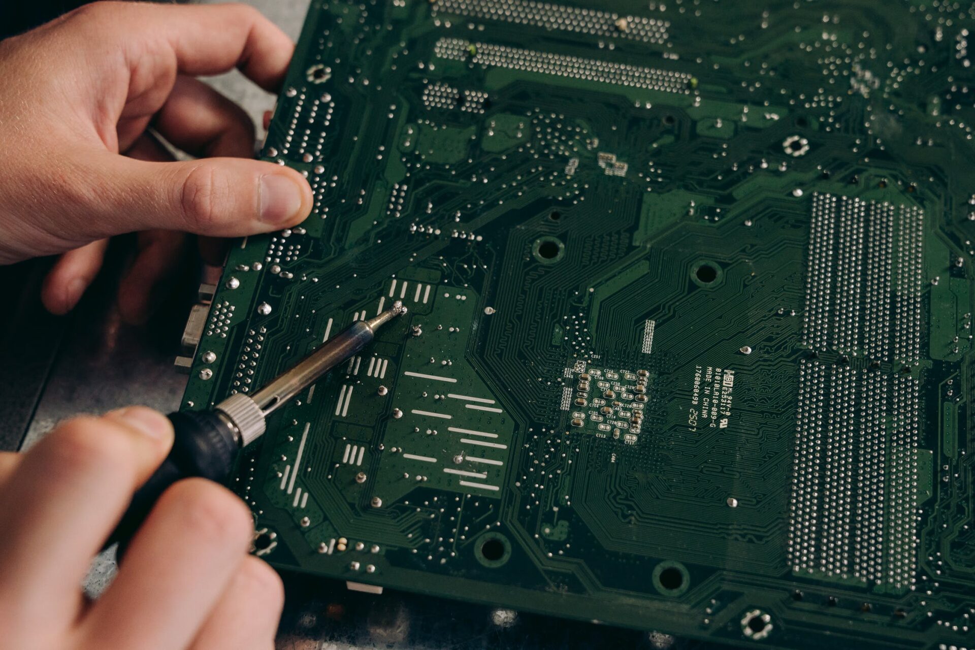 A person holding equipment on green colored board